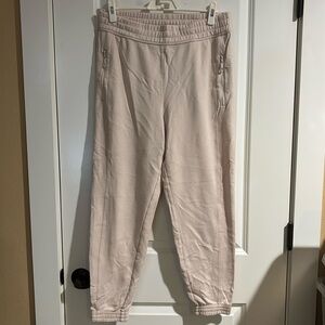 Light pink fabletics sweatpant with zipper pockets and cinched ankles size large